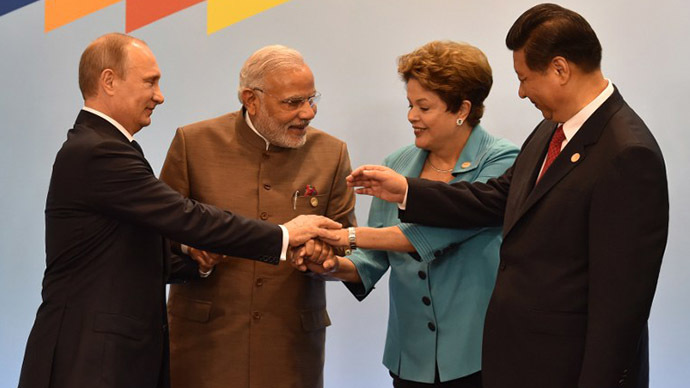 (L to R) Russia's President Vladimir Putin, India's Prime Minister Narendra Modi, Brazilian President Dilma Rousseff, China's President Xi Jinping join their hands during the official photograph of the 6th BRICS summit in Fortaleza, Brazil, on July 15, 2014. (AFP Photo / Nelson Almeida)