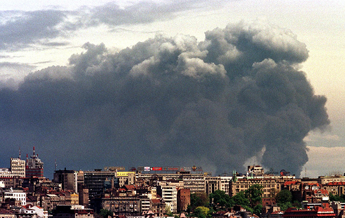 Smoke loomes over Yugoslav capital of Belgrade from Pancevo's chemical plant after NATO air strike on this April 18, 1999 file photo (Reuters)