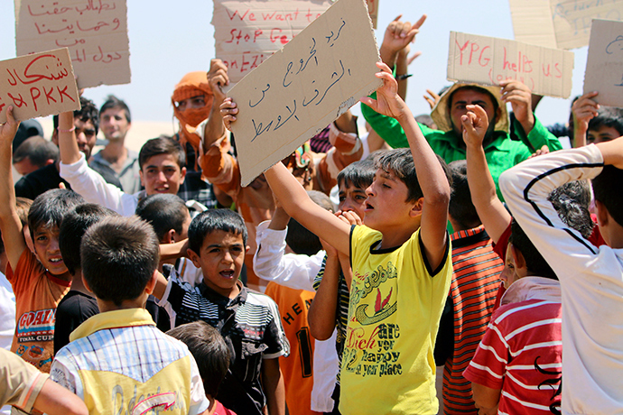 Refugees from the minority Yazidi sect, who fled the violence in the Iraqi town of Sinjar, take part in a protest to call for their evacuation from the Middle East and an end to what they say is violence against their community, at Nowruz refugee camp in Qamishli, northeastern Syria, August 17, 2014 (Reuters / Rodi Said)