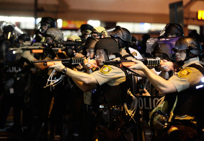 Police officers point their weapons at demonstrators protesting against the shooting death of Michael Brown in Ferguson, Missouri August 18, 2014. (Reuters / Joshua Lott)