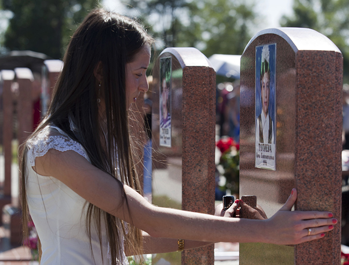 A young woman during a service in the memorial cemetery in Beslan, where those killed in the terrorist attack in school â 1 on September 1, 2004 are buried (Reuters / Anton Podgaiko)