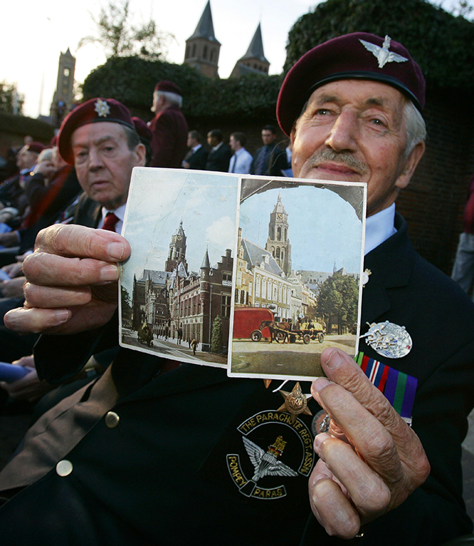 British veteran Arthur Bealy (83) shows two postcards he found in 1944 in a destroyed farm in Elst, 21 September during the 63th commemoration of Operation Market Garden, the battle of Arnhem at the Airborne monument in Arnhem (AFP Photo)