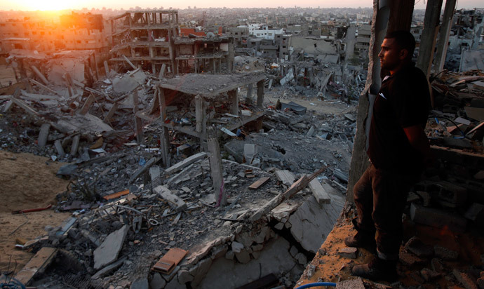 A Palestinian man looks out of his heavily damaged house at neighbouring houses which witnesses said were destroyed during the Israeli offensive, in the east of Gaza City September 3, 2014.(Reuters / Suhaib Salem )