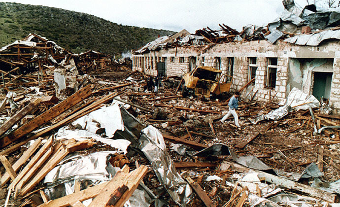 A man walks through destroyed barracks in the town of Kalinovik, south of Sarajevo, September 14, 1999 (Reuters)