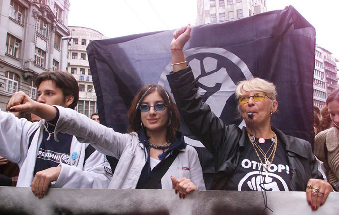 Students and teachers parade under an "Otpor" (Resistance) movement flag, 09 October 2000 in Belgrade, during a demonstration against deputies of the Serbian Parliament who gathered for a meeting in the capital. (AFP Photo / Eric Cabanis)