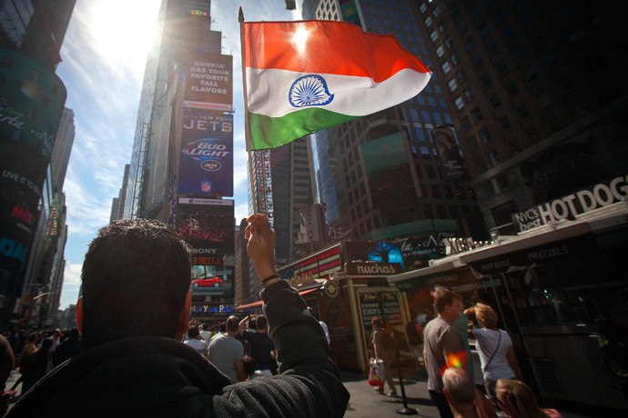 A man waves an Indian national flag as he assembles with a large crowd of people in Times Square to watch the speech by India's Prime Minister Narendra Modi simulcast on a giant screen in New York September 28, 2014. (Reuters / Carlo Allegri)