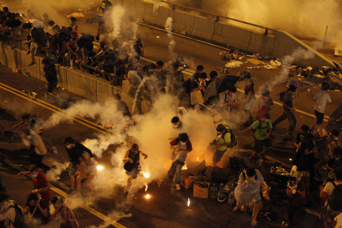Riot police fire teargas to disperse protesters after thousands of demonstrators blocked the main street to the financial Central district outside the government headquarters in Hong Kong September 29, 2014. (Reuters/Stringer)