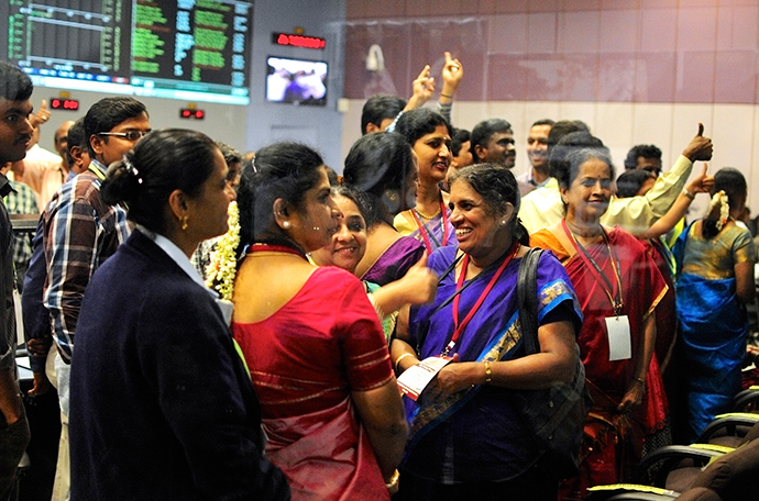 Indian Space Research Organization (ISRO) scientists and engineers cheer after India's Mars orbiter successfully entered the red planet's orbit, at their Spacecraft Control Center, in this photo taken through a glass panel, in the southern Indian city of Bangalore September 24, 2014 (Reuters / Abhishek N. Chinnappa)