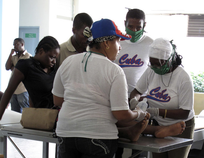 Cuban medical personnel treat an earthquake victim in the Hospital Universitaire de la Paix in central Port-au-Prince January 18, 2010. (Reuters)