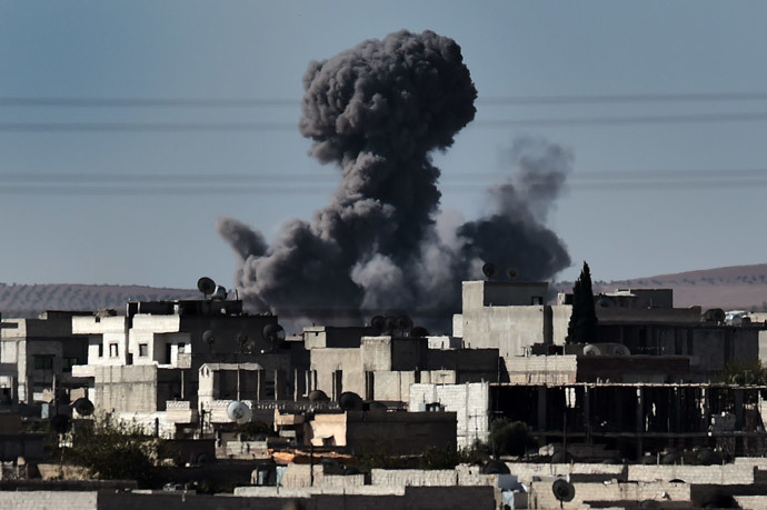 Smoke rises from the southwest of the Syrian town of Ain al-Arab, known as Kobane by the Kurds, following air strikes as seen from the Turkish-Syrian border in the southeastern town of Suruc, Sanliurfa province, on October 7, 2014. (AFP Photo / Aris Messinis)