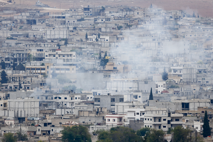 Smoke rises from the Syrian town of Kobani, seen from near the Mursitpinar border crossing on the Turkish-Syrian border in the southeastern town of Suruc in Sanliurfa province, October 16, 2014. (Reuters/Kai Pfaffenbach)