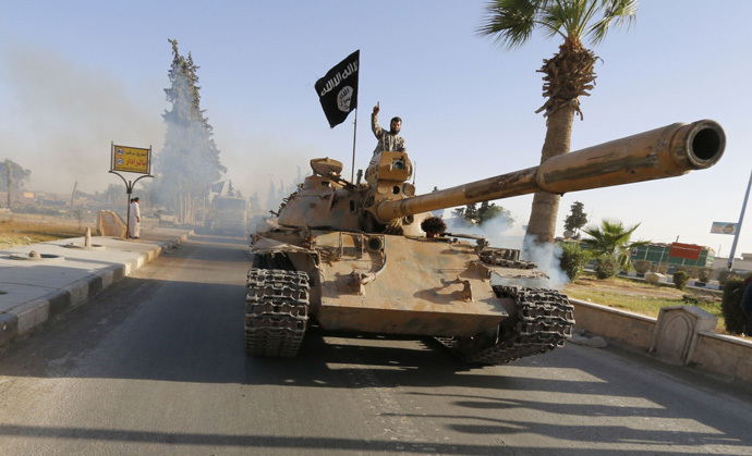 Militant Islamist fighters on a tank take part in a military parade along the streets of northern Raqqa province June 30, 2014. (Reuters/Stringer)