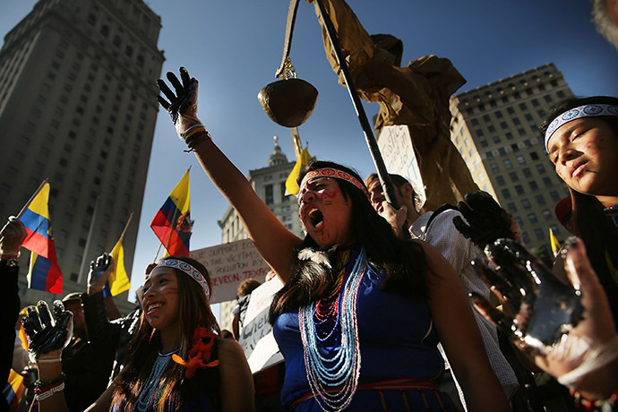Following an $18 billion judgment against Chevron from a court in Ecuador, protesters, some in traditional dress and with black hands representing oil, demonstrate in front of a United States courthouse against the Chevron Corp on October 15, 2013 in New York City. (AFP Photo/Spencer Platt)