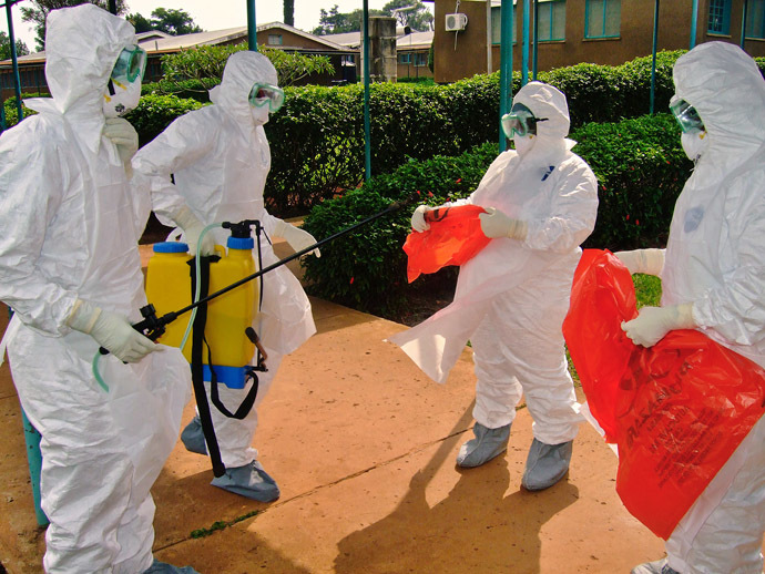 (FILES) -- A picture taken on July 28, 2012 shows officials from the World Health Organization wearing protective gear against the Ebola virus as they prepare to enter Kagadi Hospital in Uganda's western Kibale district, around 200 kilometres (125 miles) from Kampala. (AFP Photo)