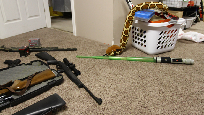 Guns and toys on the floor in a house in Trenton, Missouri.