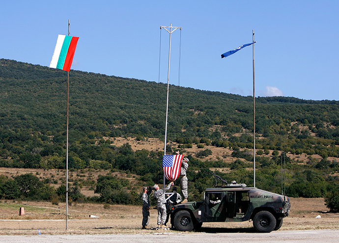 U.S. soldiers raise the U.S. flag near the Bulgarian (L) and the NATO flags at the opening ceremony of "Bulgaria Panther" military exercise at Novo Selo military base near the town of Sliven, some 350 km (217 miles) east of Sofia (Reuters / Stoyan Nenov)