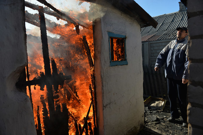 A local resident outside his burning house destroyed in the Ukrainian army's artillery attack in Donetsk's Oktyabrsky district. (RIA Novosti/Alexey Kudenko)