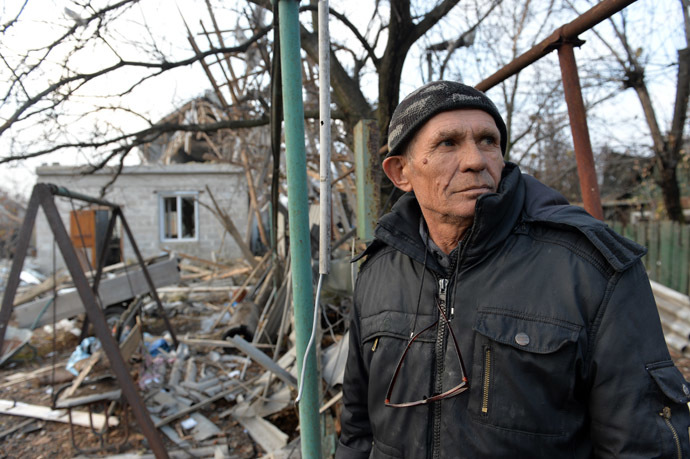 A Donetsk resident stabds next to a private house destroyed by Ukrainian army's shelling. (RIA Novosti/Alexey Kudenko)