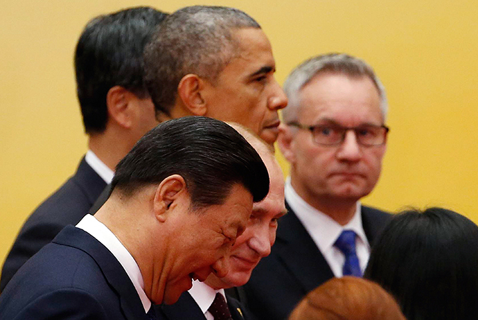 China's President Xi Jinping (front), Russia's President Vladimir Putin (2nd row), and U.S. President Barack Obama (3rd row) walk as they take part in an Asia-Pacific Economic Cooperation (APEC) family photo inside the International Convention Center at Yanqi Lake in Beijing, November 11, 2014 (Reuters / Kim Kyung-Hoon)