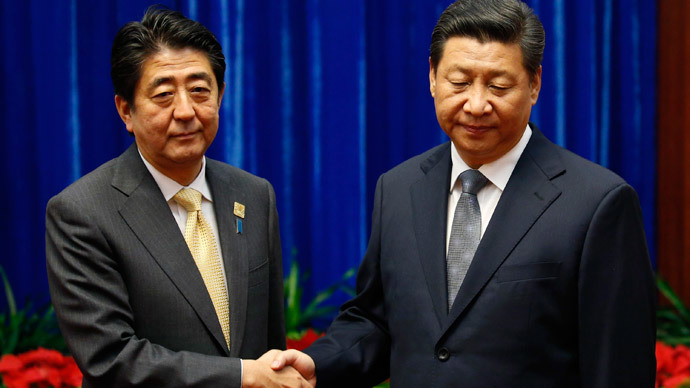 China's President Xi Jinping (R) shakes hands with Japan's Prime Minister Shinzo Abe at the Great Hall of the People on the sidelines of the Asia-Pacific Economic Cooperation (APEC) Summit in Beijing on November 10, 2014.(AFP Photo / Kim Kyung-Hoon)