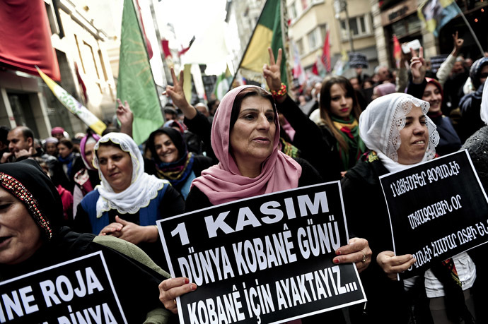 Kurds shout slogans and hold placards read, "We are here for World Kobane Day", during a rally on November 1 , 2014, along Istiklal Avenue in Istanbul, as part of an international day organised in support of Kurdish fighters trying to repel the Islamic State (IS) militants in the Syrian border town of Kobane, also known as Ain al-Arab. (AFP Photo/Ozan Kose)