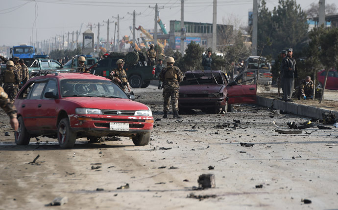 Afghan intelligence personnel inspect the site of a suicide attack on a British embassy vehicle along the Kabul-Jalalabad road in Kabul on November 27, 2014.(AFP Photo/Shah Marai)