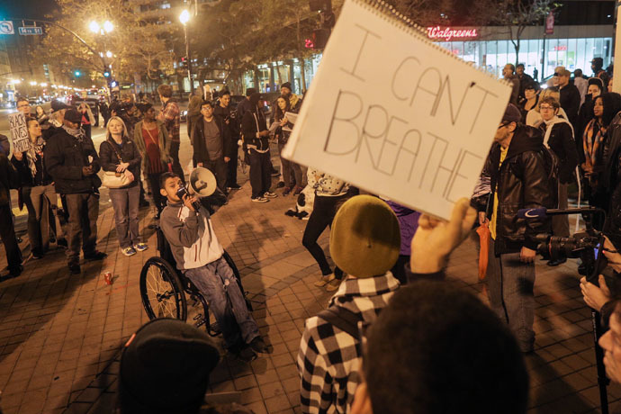 Francisco Fernandez (L) speaks to a crowd on the second night of demonstrations following a Staten Island, New York grand jury's decision not to indict a police officer in the chokehold death of Eric Garner on December 4, 2014 in Oakland, California. (Elijah Nouvelage/Getty Images/AFP)
