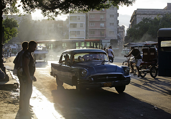 People wait to cross a street in Havana (Reuters/Desmond Boylan)