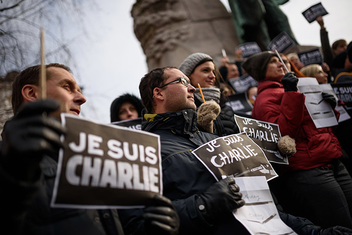 Slovenian journalists hold pens and placards reading in French "I am Charlie" during a gathering in tribute of victims of the attack on French satirical weekly Charlie Hebdo, on January 8, 2015 in Ljubljana, a day after two gunmen killed 12 people in an Islamist attack at Charlie Hebdo's editorial office in Paris. (AFP Photo/Jure Makovec)