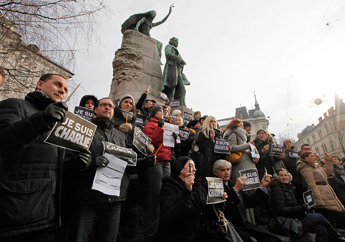 Journalists and other people hold placards reading "I am Charlie" during a minute of silence for the victims of Wednesday's shooting at the Paris offices of weekly newspaper Charlie Hebdo in Ljubljana January 8, 2015 (Reuters / Srdjan Zivulovic)