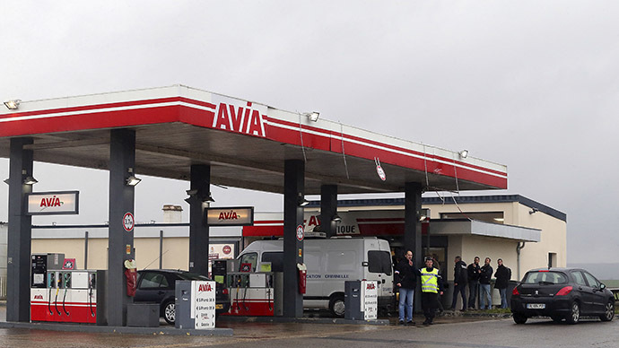 A Gendarmerie criminal identification van is parked in front of an Avia gas station in Villers-Cotterets, north-east of Paris, on January 8, 2015, where the two armed suspects from the attack on French satirical weekly newspaper Charlie Hebdo were spotted in a gray Clio. (AFP Photo/Francois Nascimbeni)