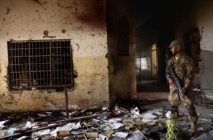 In this photograph taken on December 18, 2014, a Pakistani army soldier stands guard at the site of a militant attack on an army-run school in Peshawar. (AFP Photo / A Majeed / Files)