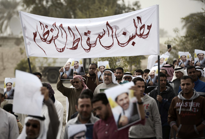 Bahraini men take part in a protest against the arrest of Sheikh Ali Salman, head of the Shiite opposition movement Al-Wefaq on January 9, 2015 in the village of Karzakan, South of Manama.(AFP Photo/Mohammed Al-Shaikh)