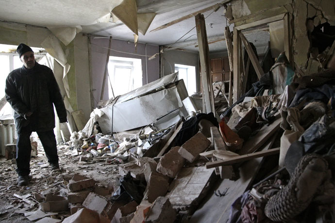 Local resident Nikolai, 82, inspects his apartment, which according to locals, was recently destroyed by shelling, in Donetsk, eastern Ukraine, January 15, 2015. (Reuters/Alexander Ermochenko)