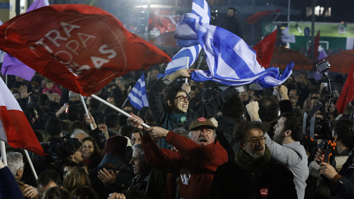 Supporters of radical leftist Syriza party chant slogans and wave Greek national and other flags after winning elections in Athens, January 25, 2015. (Reuters/Alkis Konstantinidis)