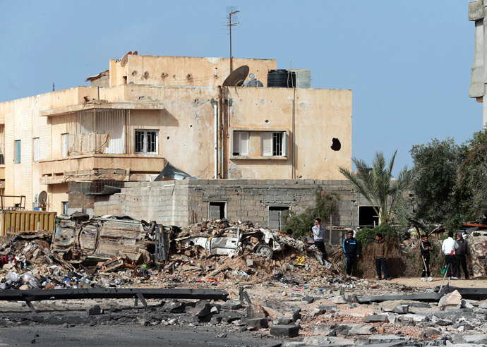 People stand near the site of an explosion in Benghazi February 6, 2015. (Reuters / Esam Omran Al-Fetori)
