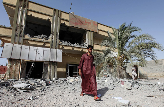 A man walks past the premises of a transport company which the Libyan government said was destroyed by NATO air strikes in Zliten, about 150km (93.2 miles) east of Tripoli July 21, 2011. (Reuters/Ismail Zitouny)