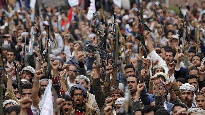 Shi'ite Muslim rebels hold up their weapons during a rally against air strikes in Sanaa March 26, 2015.(Reuters / Khaled Abdullah)