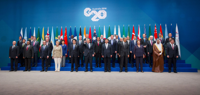 Australia's Prime Minister Tony Abbott (C) points to photographers as he and other leaders pose for a group photo during the G20 summit in Brisbane November 15, 2014. (Reuters/Pablo Martinez Monsivais)