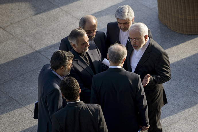 Iranian Foreign Minister Javad Zarif (R) and Head of Iranian Atomic Energy Organization Ali Akbar Salehi talk while other members of their delegation listen after a meeting with U.S. Secretary of State John Kerry and U.S. officials at the Beau Rivage Palace Hotel in Lausanne March 27, 2015 (Reuters / Brendan Smialowski)