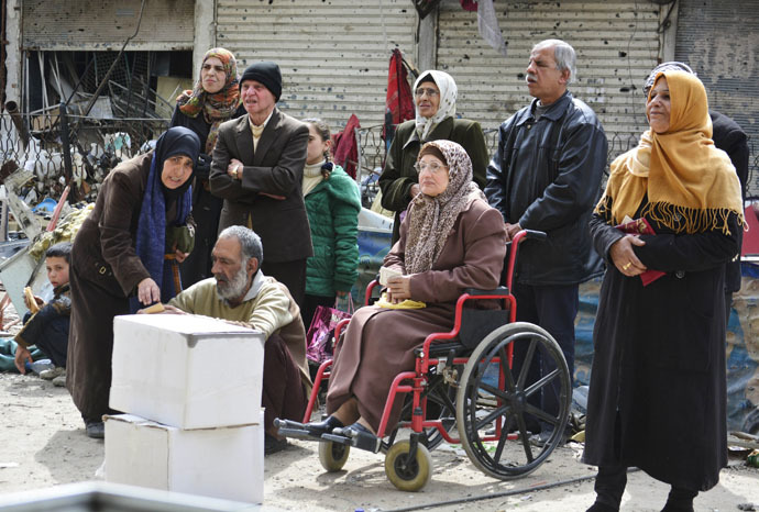Residents wait to receive humanitarian aid at the Palestinian refugee camp of Yarmouk, in Damascus March 11, 2015. (Reuters)