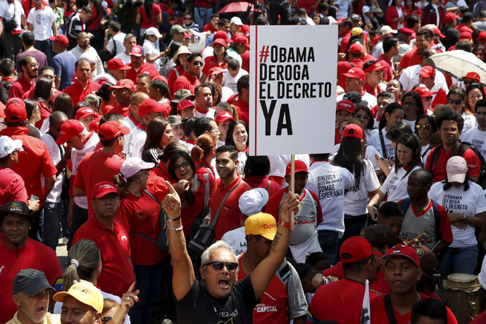 Supporters of Venezuela's President Nicolas Maduro hold a placard and shout during a protest against imperialism, in Caracas March 24, 2015. (Reuters/Carlos Garcia Rawlins)