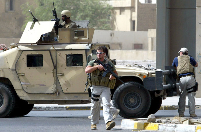  A picture taken on July 5, 2005 shows contractors of the US private security firm Blackwater securing the site of a roadside bomb attack near the Iranian embassy in central Baghdad. (AFP Photo)