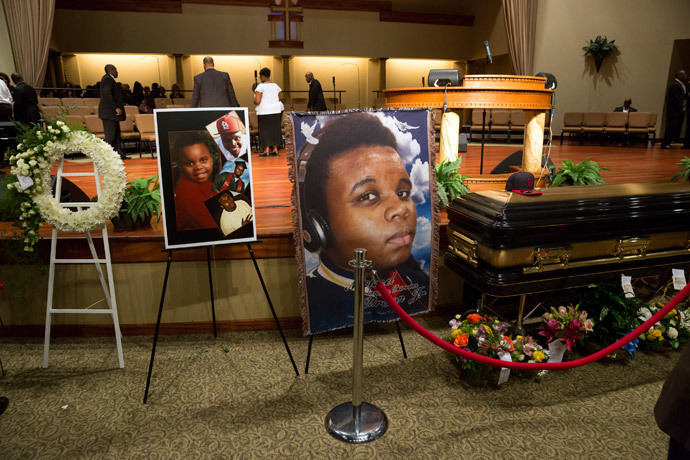 Photos surround the casket of Michael Brown at Friendly Temple Missionary Baptist Church in St. Louis, Missouri, August 25, 2014. (Reuters / Richard Perry / Pool)