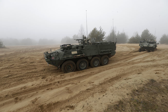 Soldiers of the U.S. Army's 2nd Cavalry Regiment, deployed in Latvia as part of NATO's Operation Atlantic Resolve, ride in armored vehicles named "Stryker" during a joint military exercise in Adazi February 26, 2015. (Reuters/Ints Kalnins)