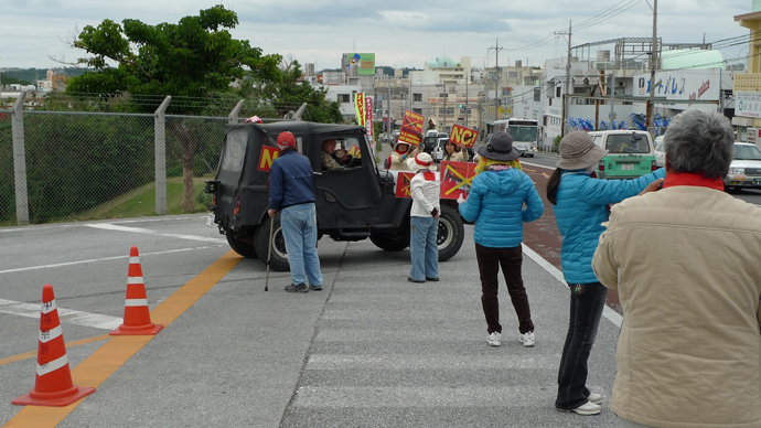 Protesters besieging US air force Jeep at Futenme Base.(Photo by Andre Vltchek)