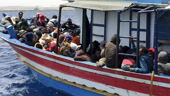 Illegal migrants who attempted to sail to Europe, sit in a boat carrying them back to Libya, after their boat was intercepted at sea by the Libyan coast guard, at Khoms, Libya May 6, 2015. (Reuters/Aymen Elsahli)