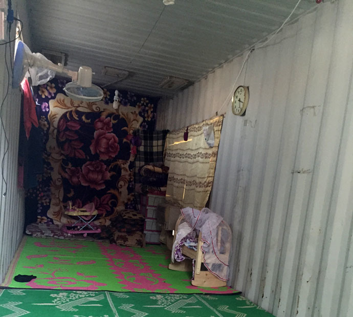 The home of a displaced family on the Najaf-Karbala highway. Their newborn daughter sleeps in the wooden cot. Photo by Eisa Ali