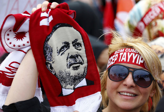 A supporter of Turkish President Tayyip Erdogan waves a scarf with an image of the president during a ceremony to mark the 562nd anniversary of the conquest of the city by Ottoman Turks, in Istanbul, Turkey, May 30, 2015. (Reuters/Murad Sezer)