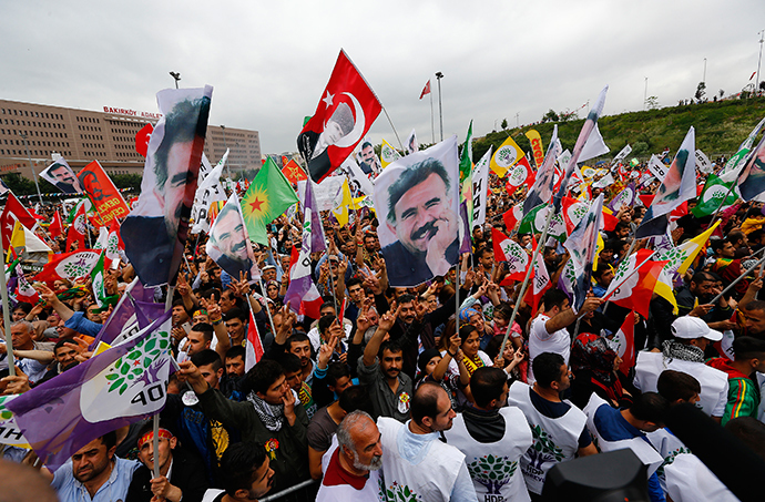 Supporters of the Pro-Kurdish Peoples' Democratic Party (HDP) wave flags with a picture the jailed Kurdish militant leader Abdullah Ocalan, during a gathering to celebrate their party's victory during the parliamentary election, in Istanbul, Turkey, June 8, 2015 (Reuters / Murad Sezer)